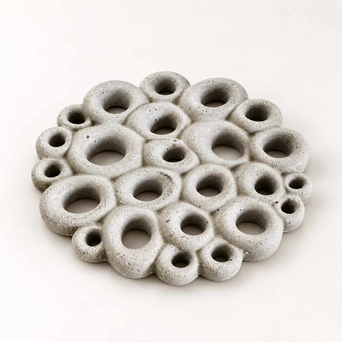 Coral-texture concrete coaster in natural concrete – studio view