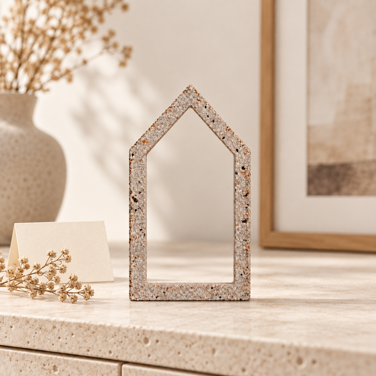 Small concrete house as table decor with place card and picture frame