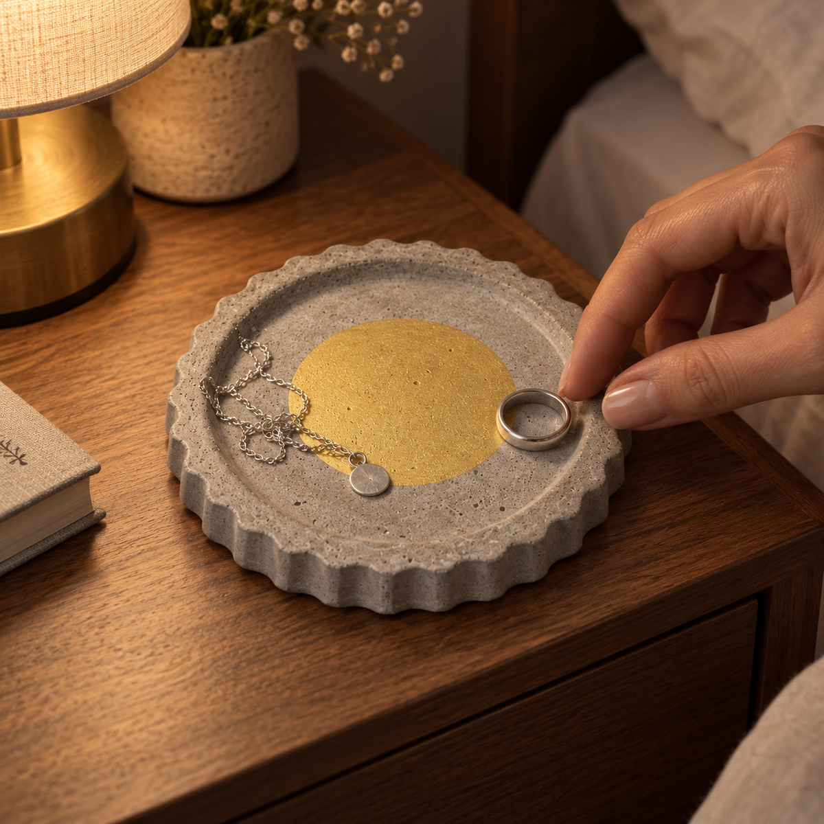 Round concrete coaster with scalloped edge – gold-tone circle – shown in use