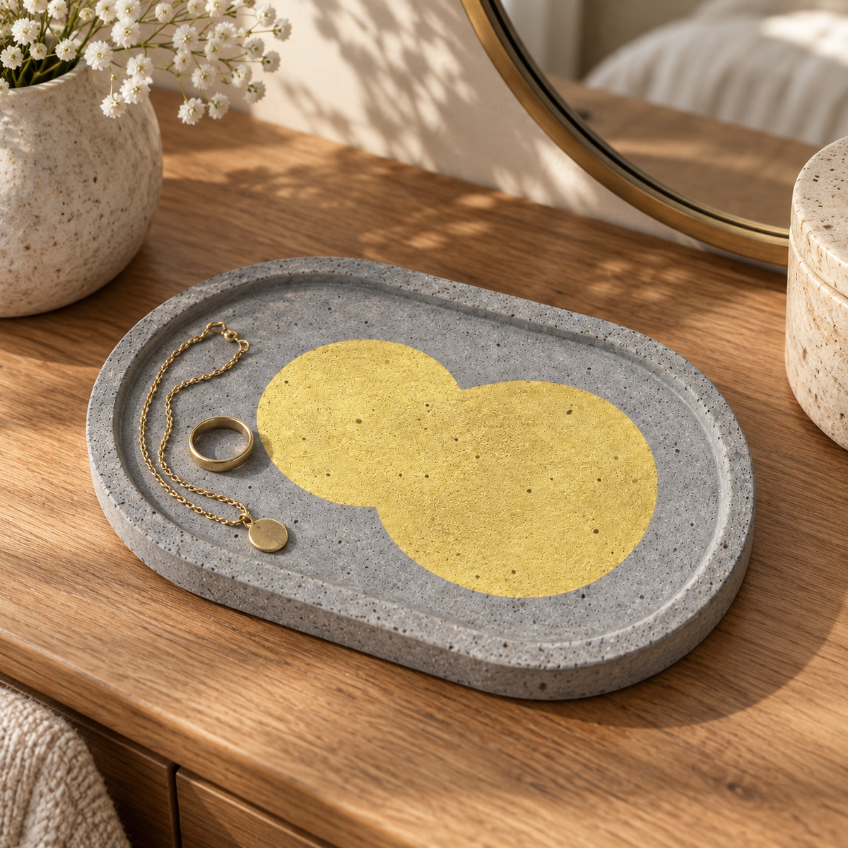 Oval concrete coaster – gold-tone double circle – shown in use