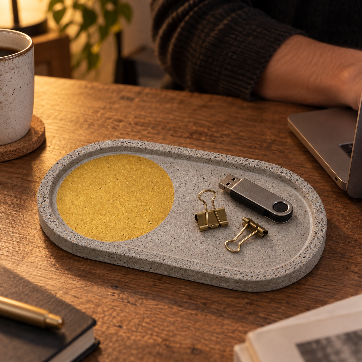 Elongated oval concrete coaster – gold-tone circle – shown in use