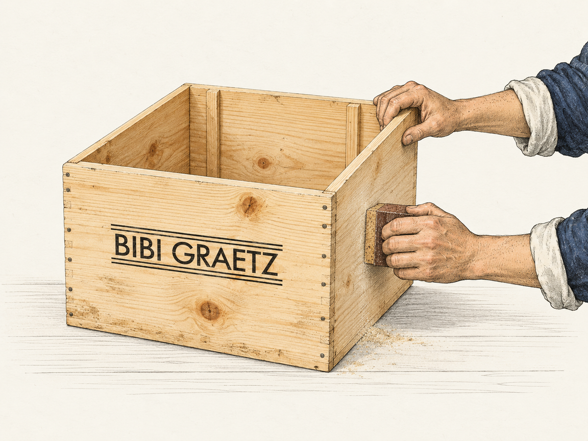 An original Bibi Graetz wine crate being hand-sanded in the Designeria workshop
