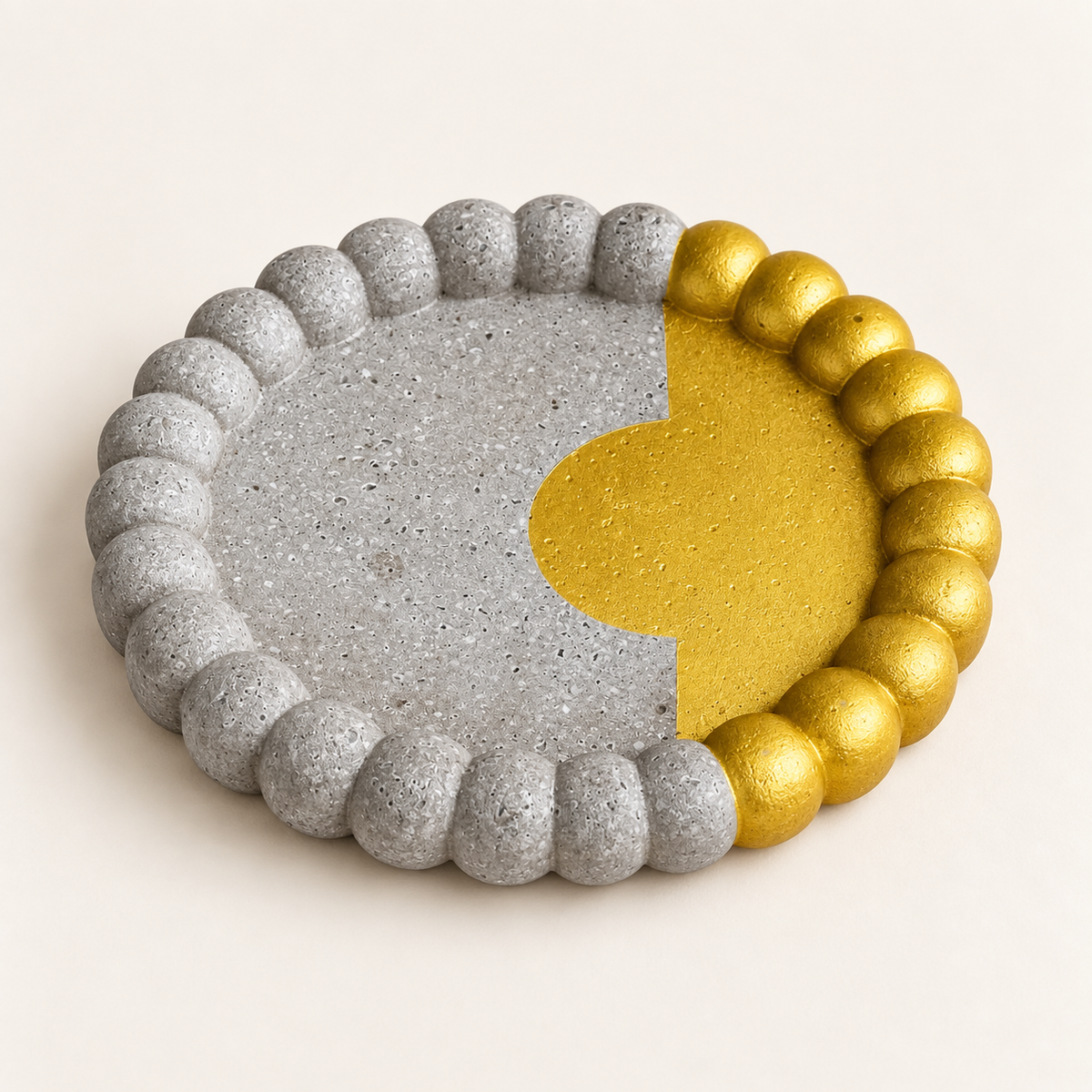 Small ribbed concrete coaster – gold circle with border – angled view
