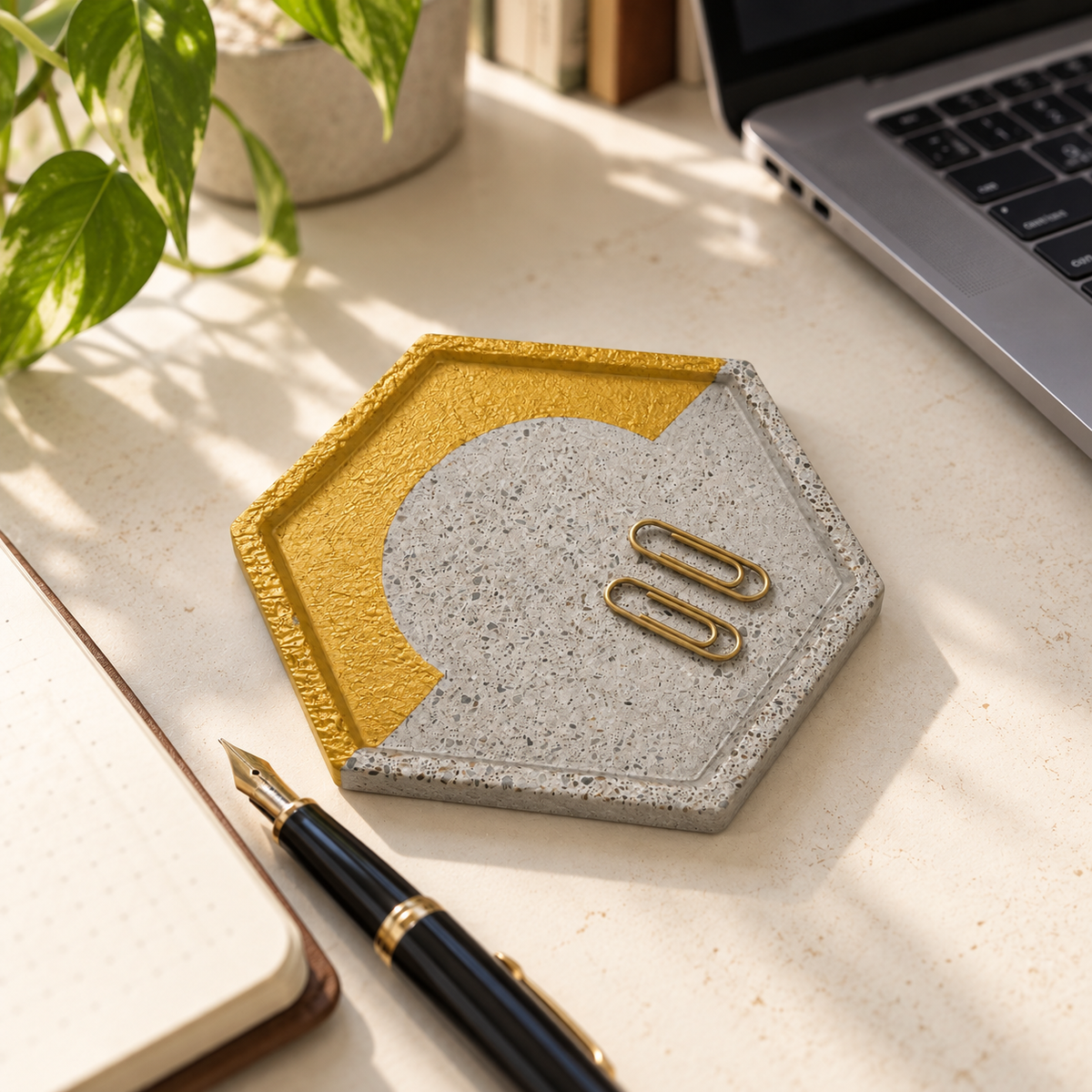 Arc-design hexagon concrete coaster used as a catchall in a bright home office