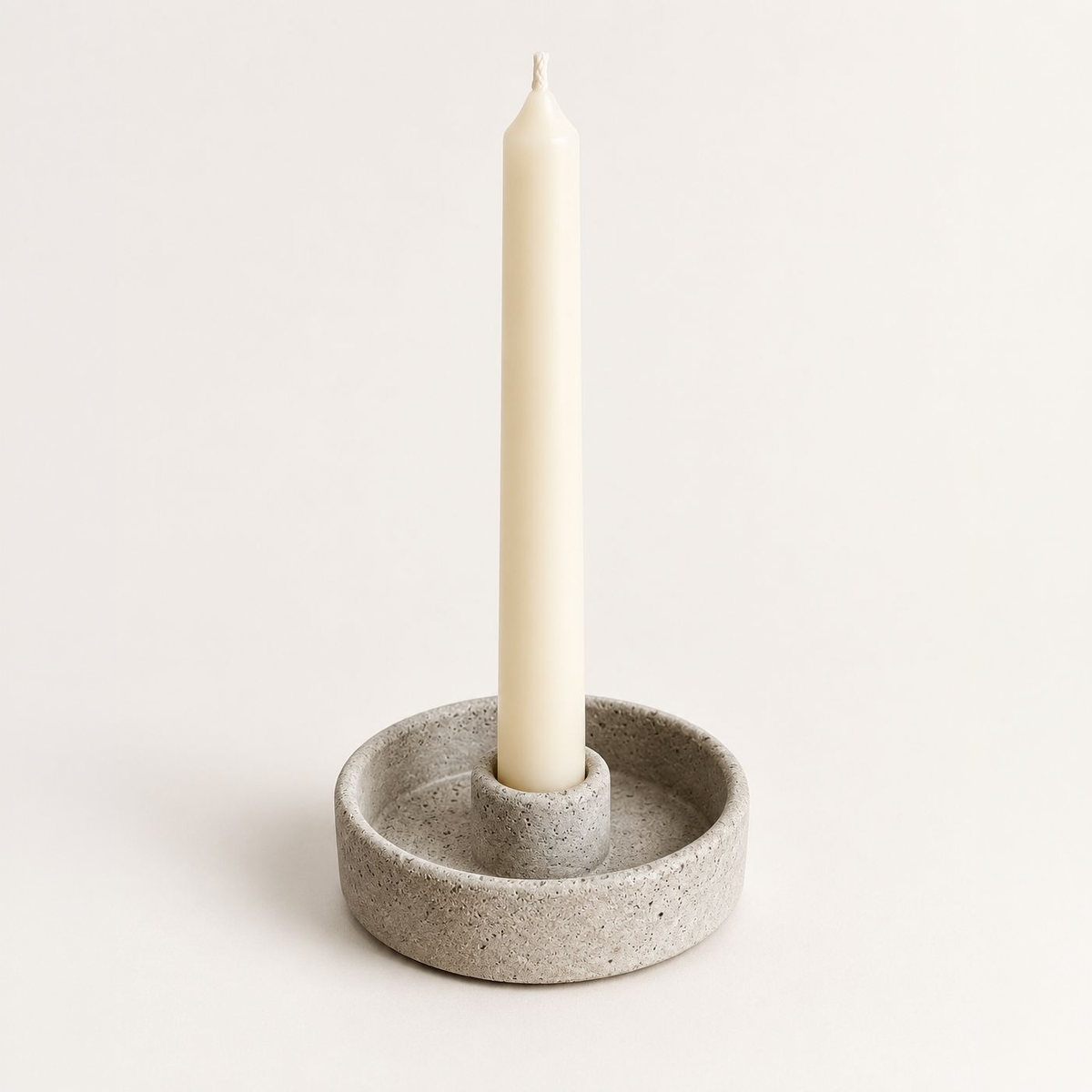 Round natural concrete candle holder with taper candle