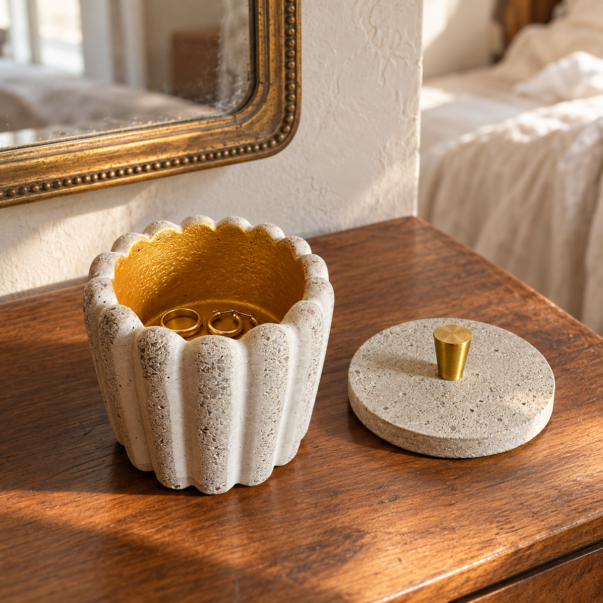 Concrete pot with gold-tone interior used as a jewelry tray