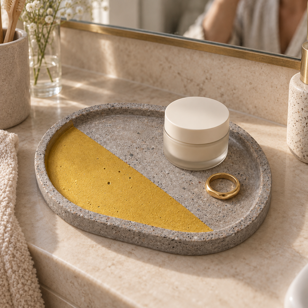 Oval concrete coaster – diagonal gold-tone accent – shown in use