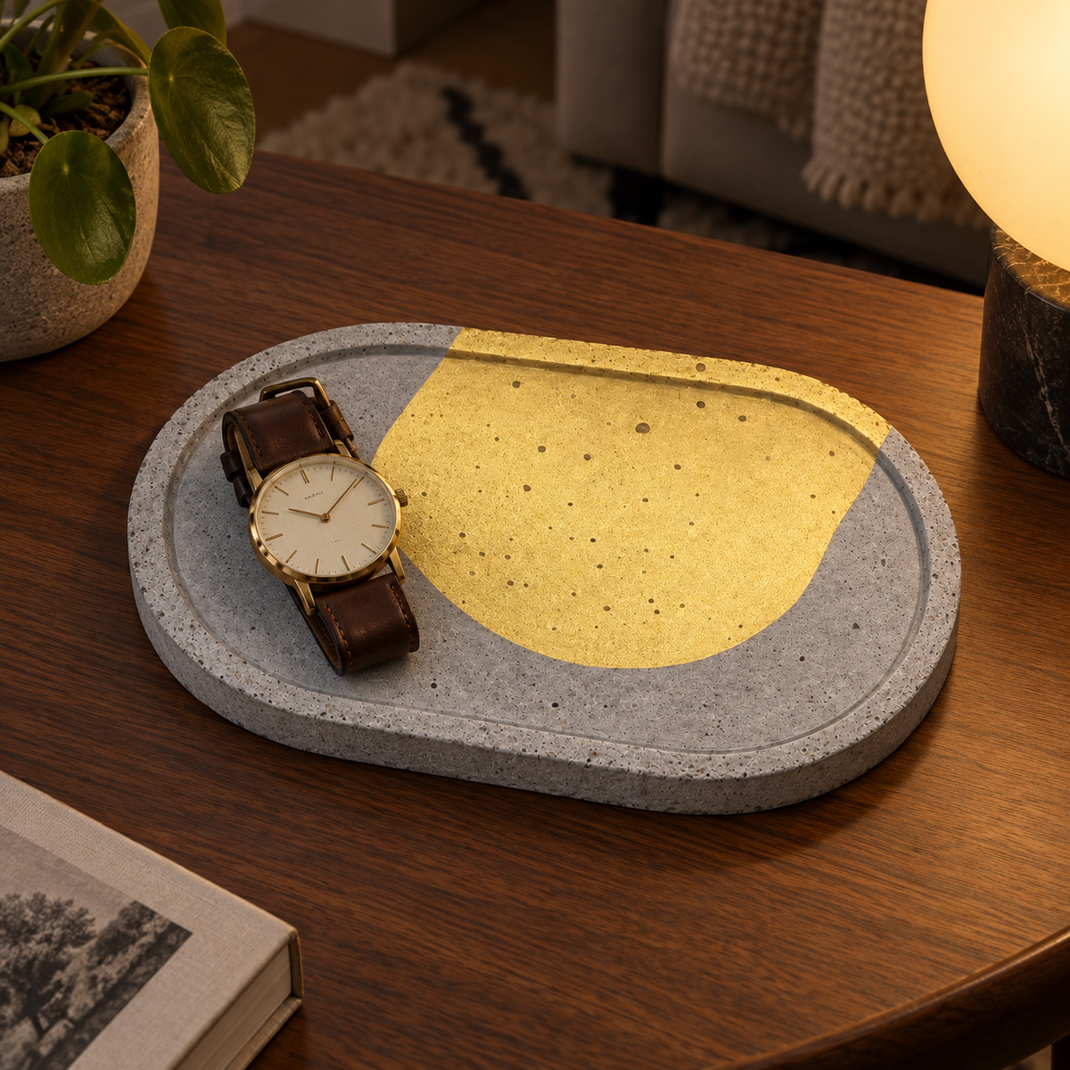 Oval concrete coaster – gold-tone arc – shown in use
