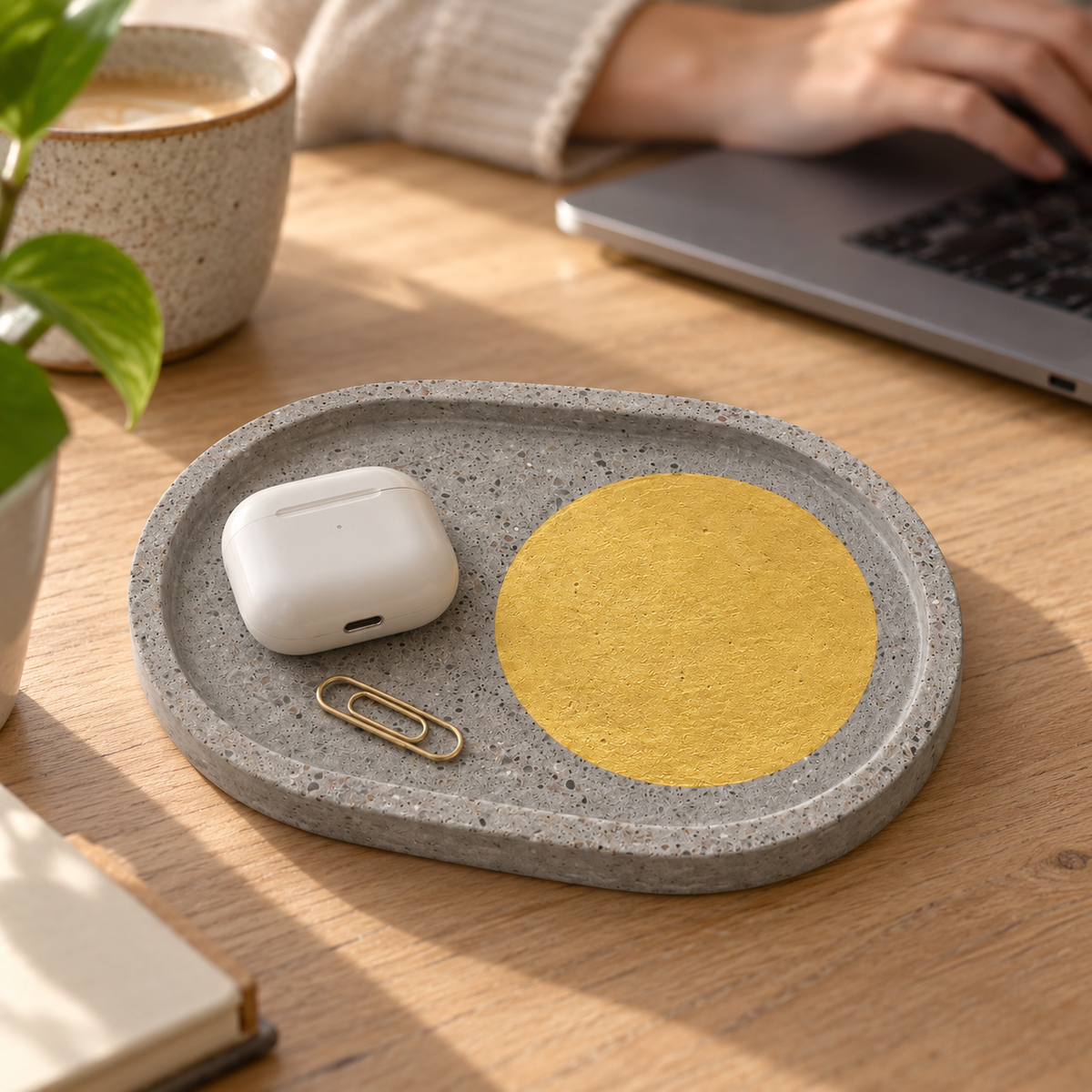 Oval concrete coaster – gold-tone circle – shown in use