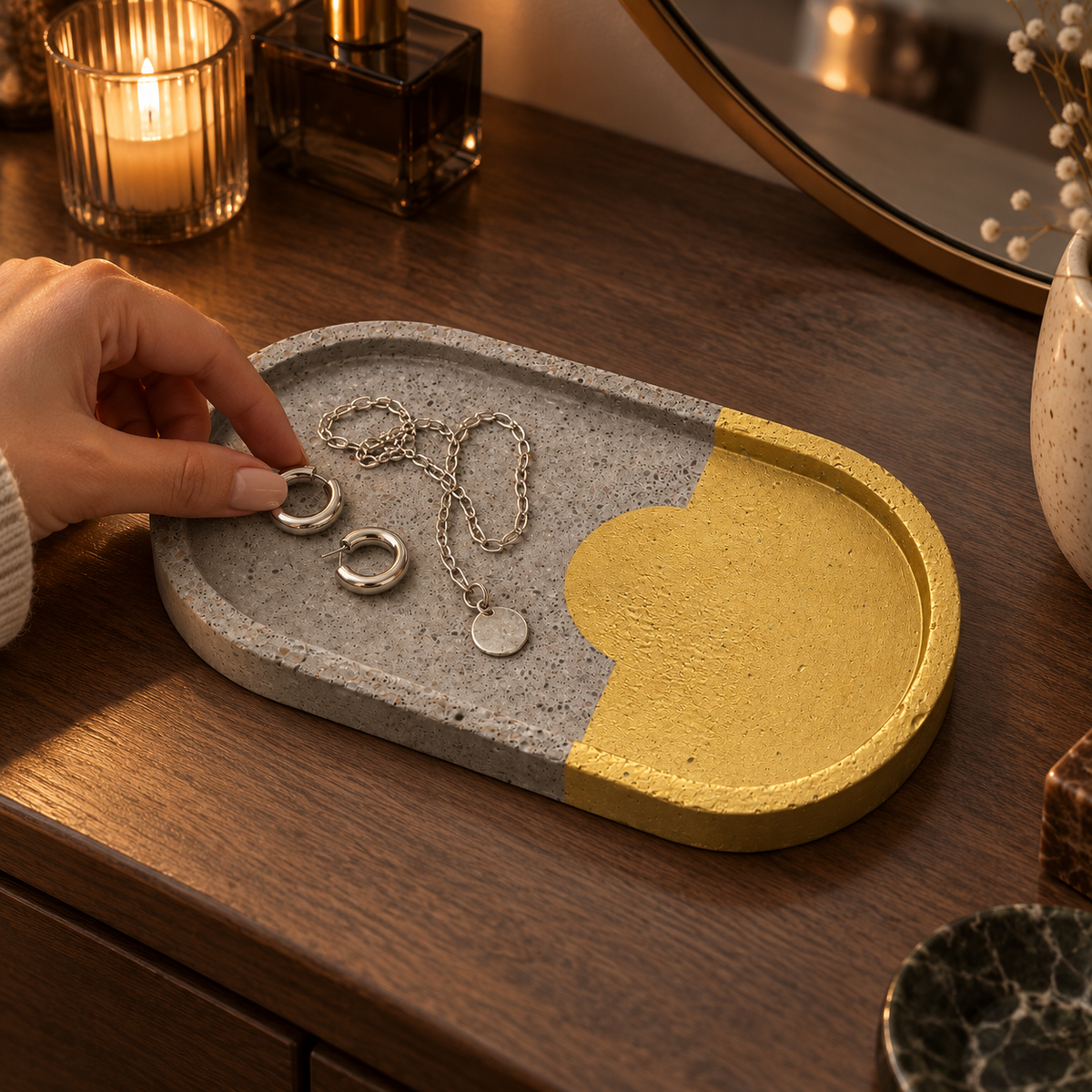 Elongated oval concrete coaster – gold-tone area with arc – shown in use