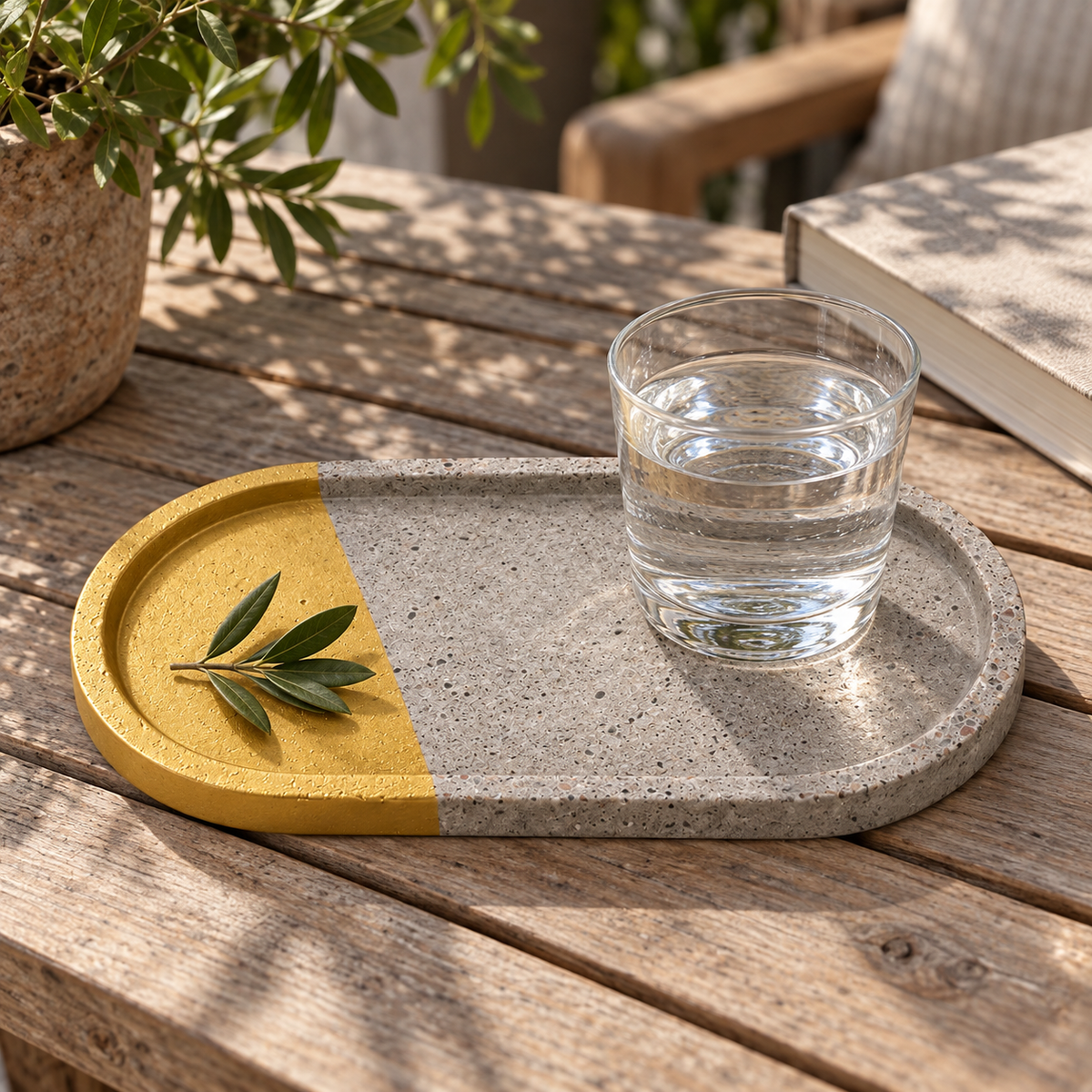 Elongated oval concrete coaster – side accent in gold tone – shown in use