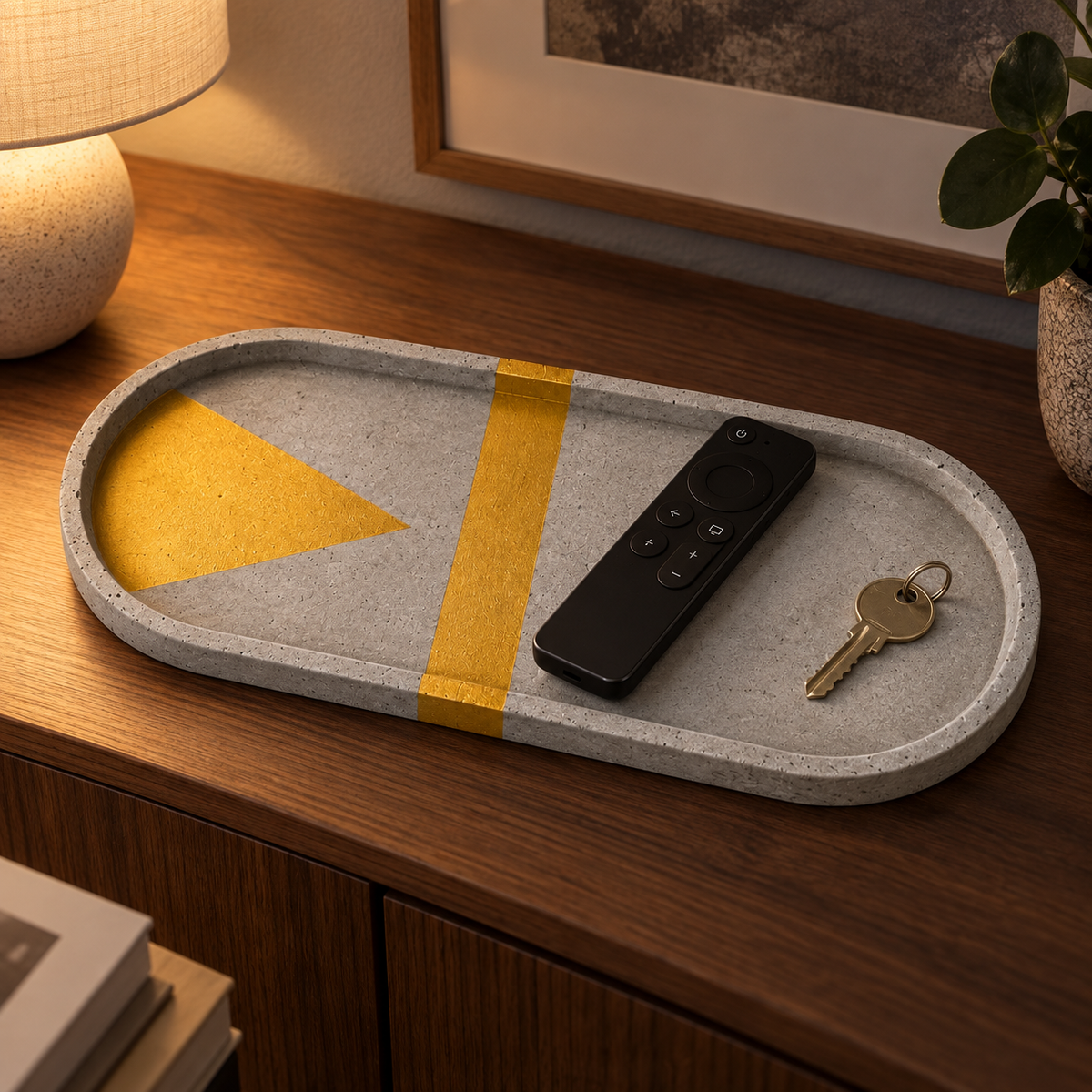 XXL oval concrete coaster – gold triangle with cross stripe – shown in use