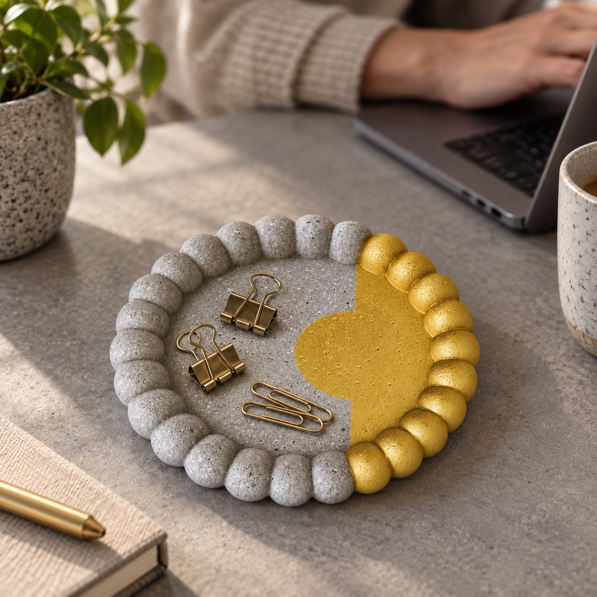 Small Bubble concrete coaster – gold circle with border – shown in use