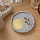 Small round concrete coaster – gold-tone circle – shown in use