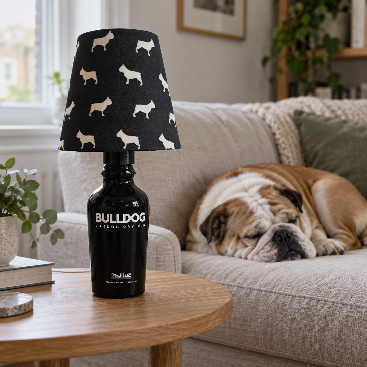 Bulldog bottle lamp in focus by day, with a sleeping bulldog on the sofa in the background