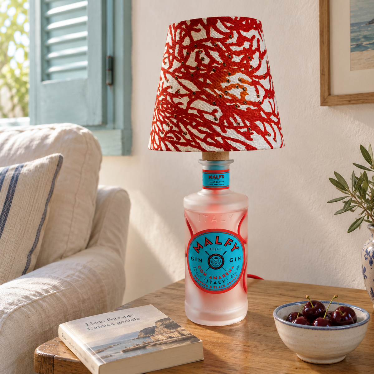 Malfy Con Amarena bottle lamp switched off in an Italian reading nook by day