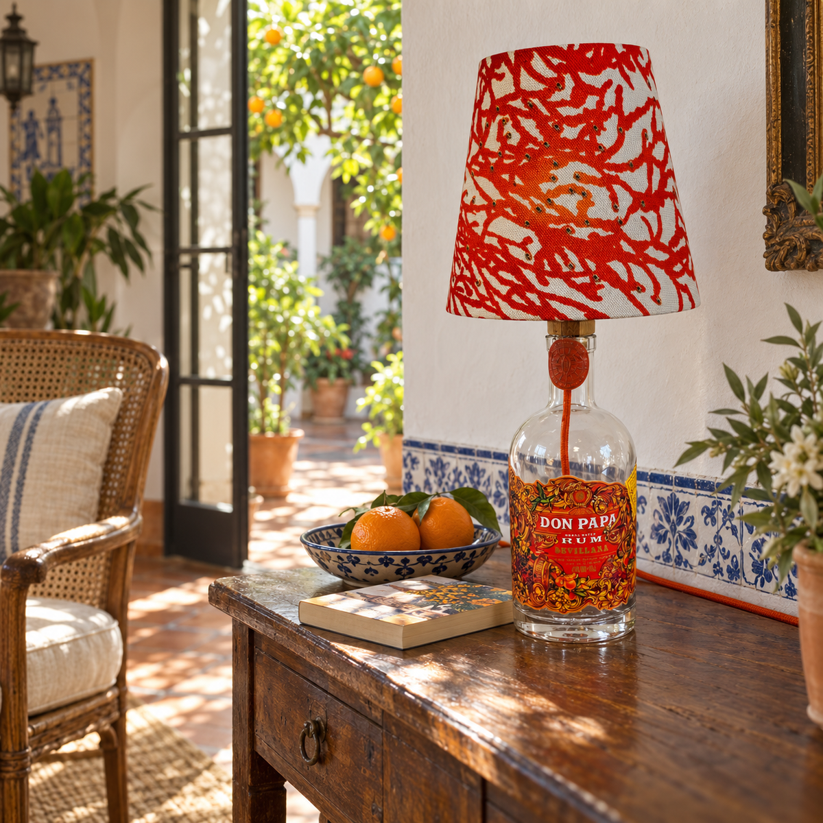 Don Papa Sevillana bottle lamp switched off in an Andalusian loggia by day