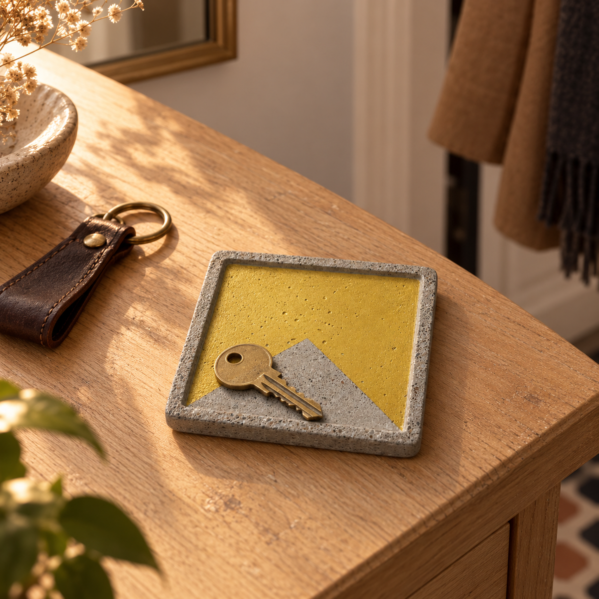 Square concrete coaster with large concrete triangle used as a key tray