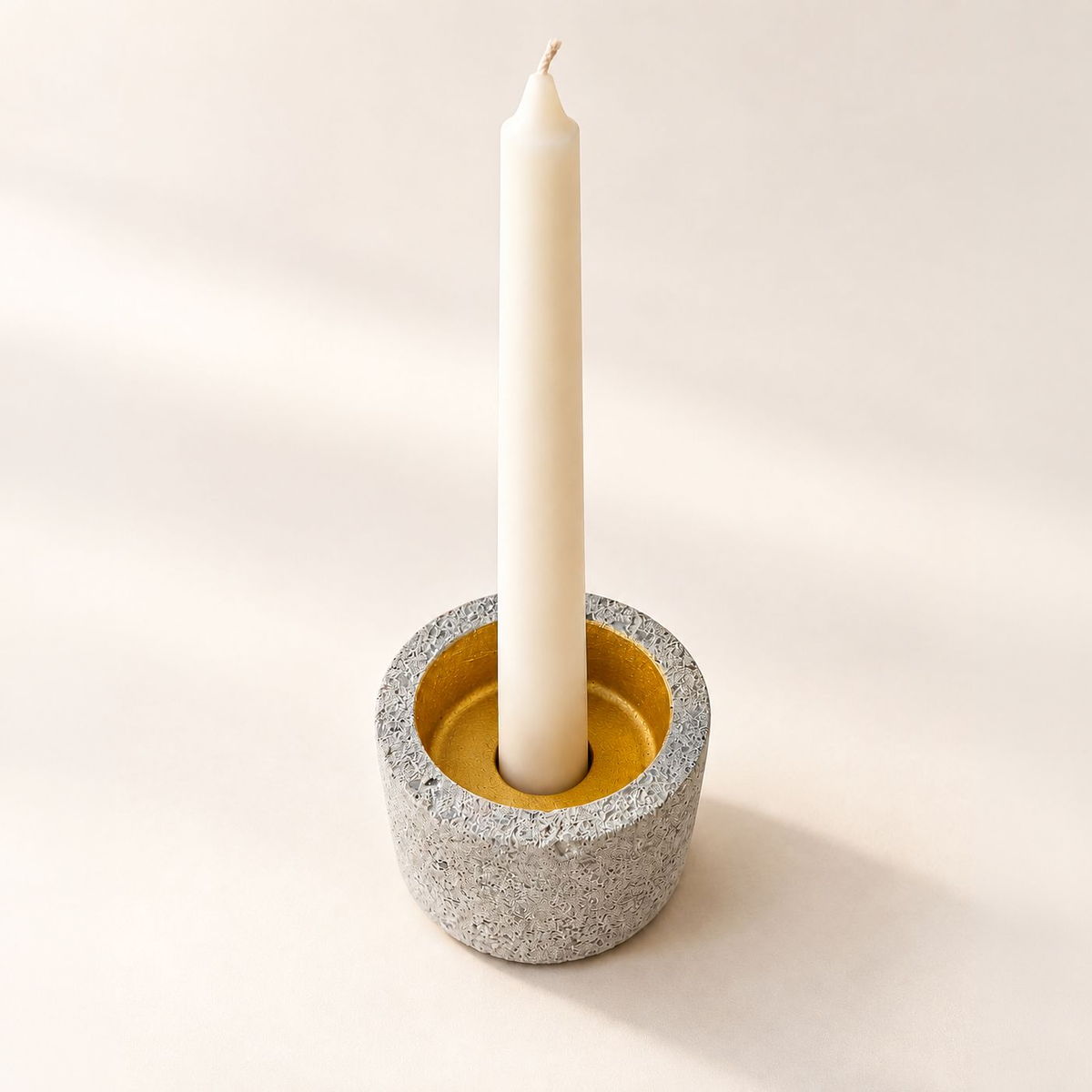 Small Vario with gold accent and slim taper candle in recessed opening
